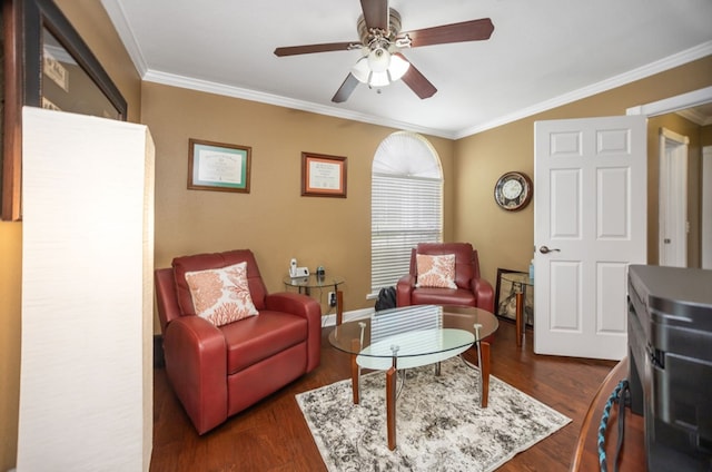 sitting room featuring ceiling fan, dark wood finished floors, ornamental molding, and baseboards