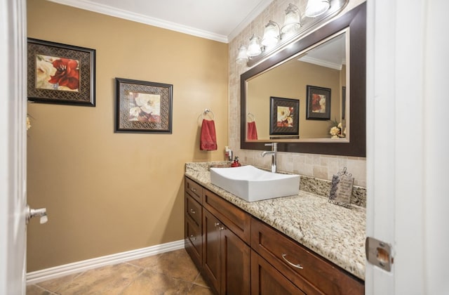 bathroom with baseboards, crown molding, tile patterned flooring, and vanity