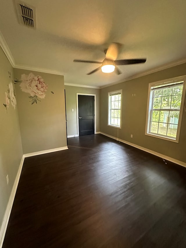 6197 State Highway 147, Center, TX 75935 - unfurnished room featuring dark wood-style flooring, ornamental molding, and a ceiling fan