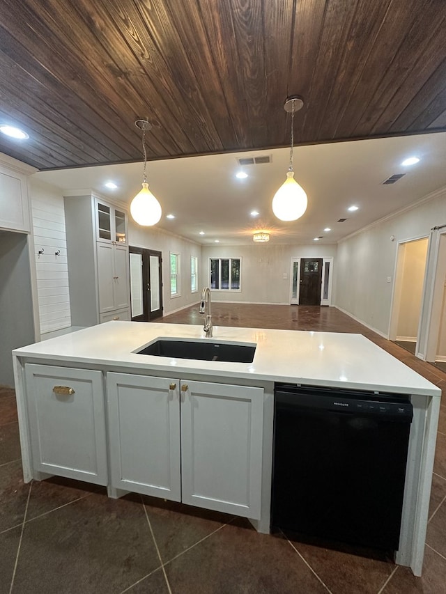 6197 State Highway 147, Center, TX 75935 - kitchen featuring black dishwasher, white cabinets, an island with sink, decorative light fixtures, and light countertops