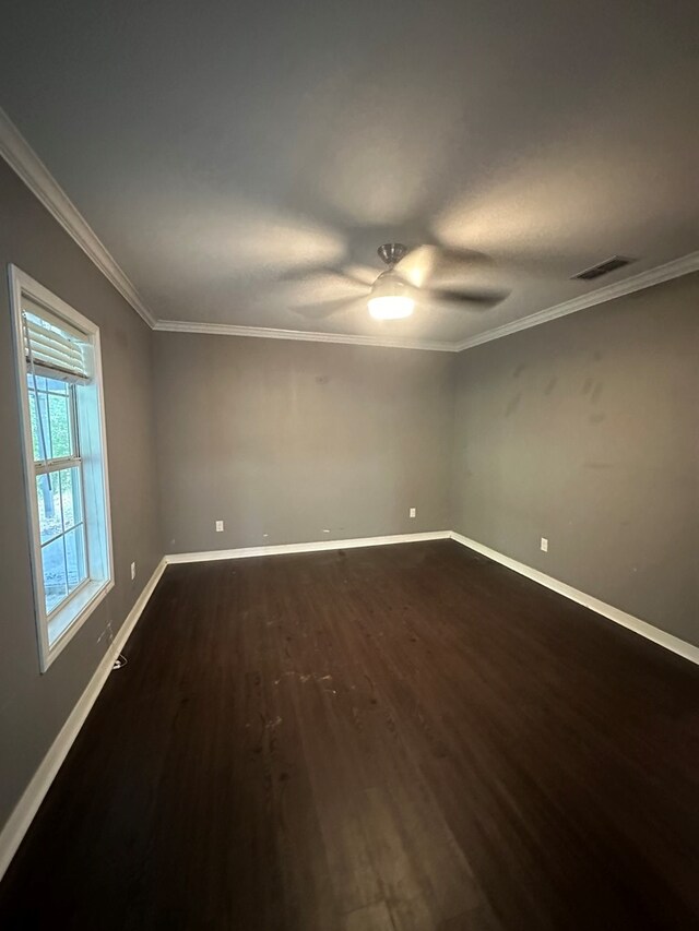 6197 State Highway 147, Center, TX 75935 - unfurnished room featuring dark wood-style flooring, ceiling fan, and crown molding