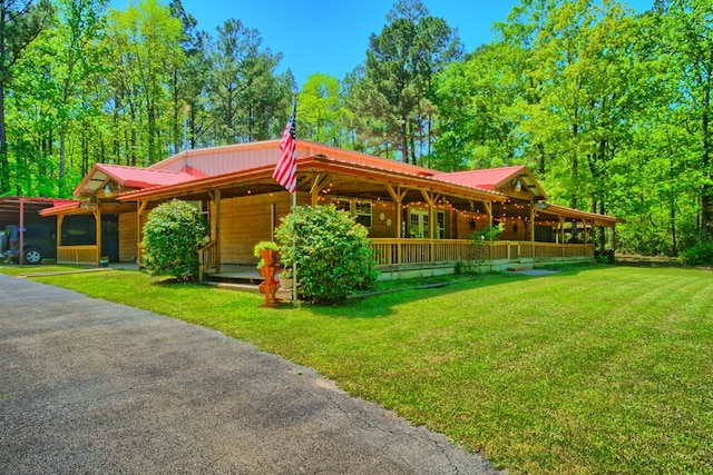 590 Angela Ln, Hemphill, TX 75948 - view of front of house featuring a front yard, metal roof, and a porch