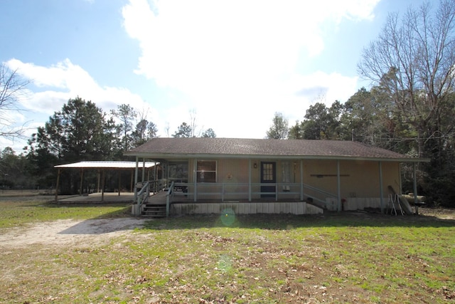 view of front of house with a front lawn, a carport, and a porch