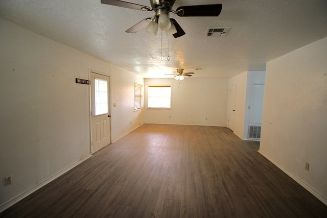 spare room featuring dark wood-type flooring and a textured ceiling