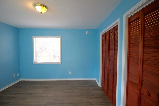 unfurnished bedroom featuring dark wood-type flooring