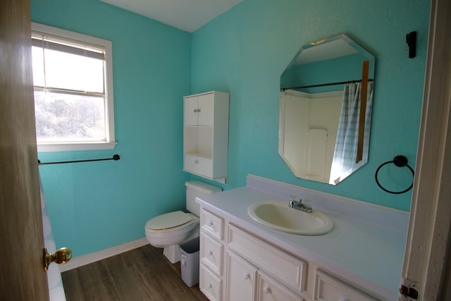 bathroom featuring vanity, toilet, a shower with shower curtain, and wood-type flooring