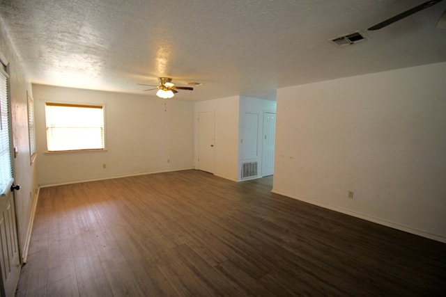 empty room featuring dark hardwood / wood-style floors, a textured ceiling, and ceiling fan