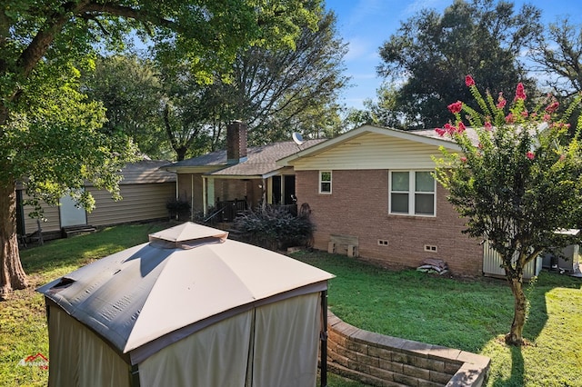 back of house with a lawn