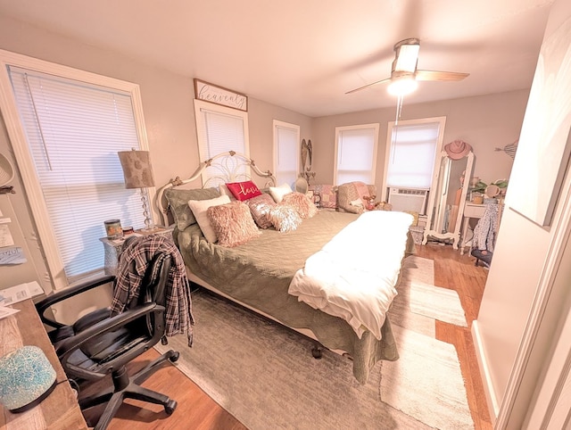 663 Mount Carmel Rd, Lufkin, TX 75904 - bedroom featuring wood finished floors, a ceiling fan, a desk, and cooling unit