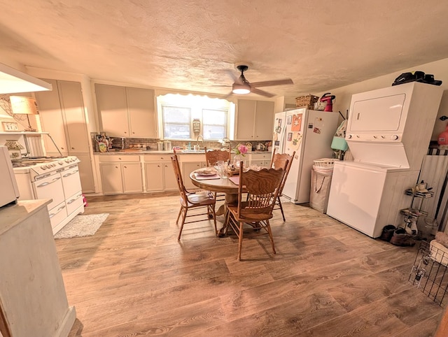 663 Mount Carmel Rd, Lufkin, TX 75904 - dining space featuring stacked washer and clothes dryer, ceiling fan, light wood finished floors, and a textured ceiling