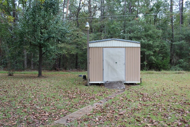 view of outbuilding with a yard