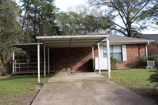 view of parking featuring a lawn and a carport