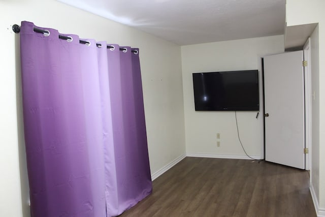 spare room featuring dark wood-type flooring