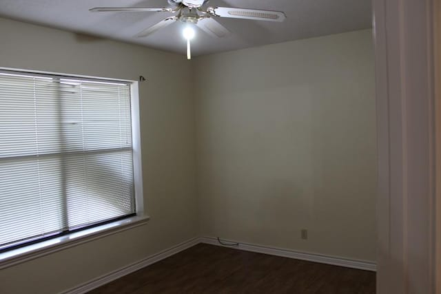 unfurnished room featuring ceiling fan and dark hardwood / wood-style floors