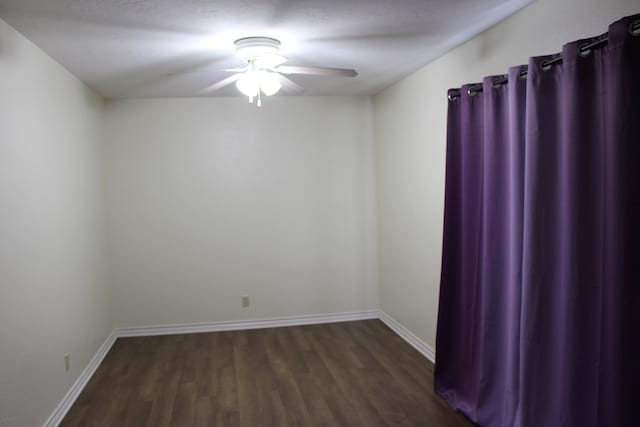 spare room with ceiling fan and dark hardwood / wood-style floors