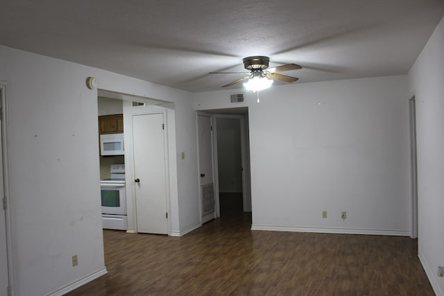 empty room with ceiling fan, dark hardwood / wood-style flooring, and a textured ceiling