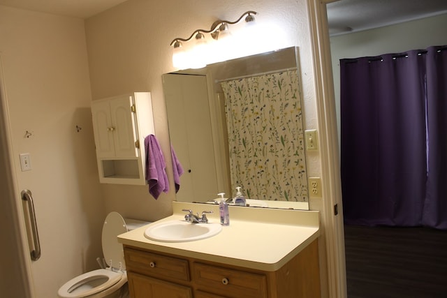 bathroom featuring toilet and vanity