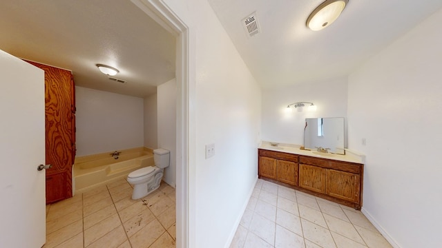 bathroom with a tub to relax in, tile patterned floors, a textured ceiling, toilet, and vanity