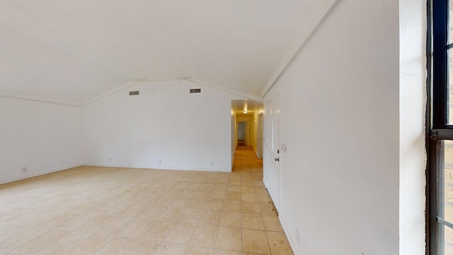 empty room with a healthy amount of sunlight and lofted ceiling