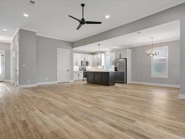 829 Village Gate Cir, Nacogdoches, TX 75961 - unfurnished living room with a chandelier, ceiling fan, ornamental molding, baseboards, and light wood-style floors