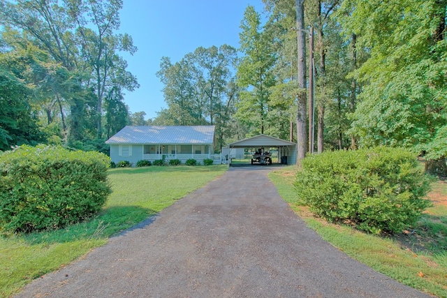 single story home with a front lawn and a carport