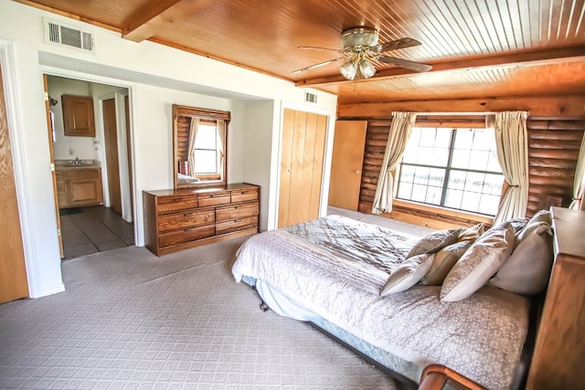 carpeted bedroom featuring beamed ceiling, wood ceiling, visible vents, and rustic walls