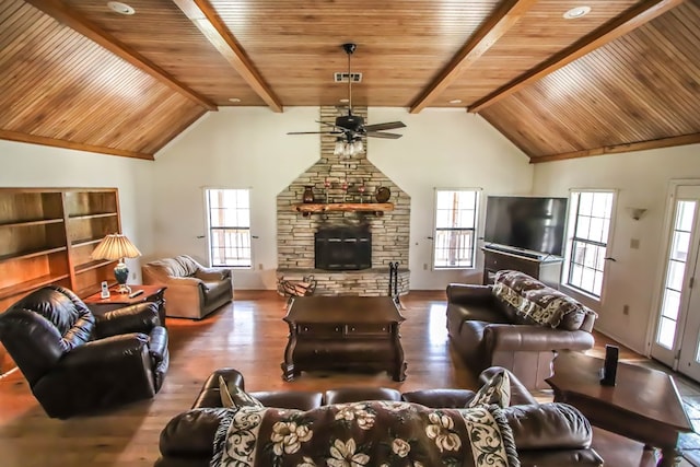 living area featuring a wealth of natural light, a fireplace, and wood finished floors