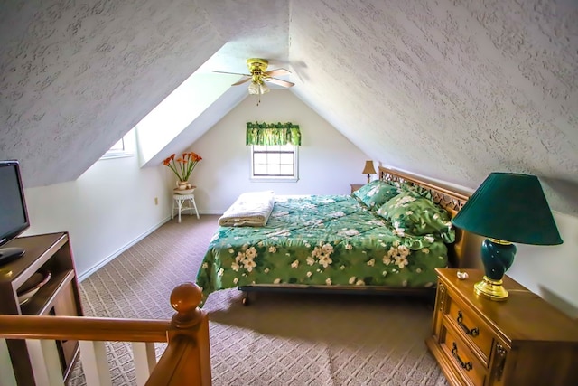 bedroom featuring ceiling fan, vaulted ceiling, carpet flooring, and a textured ceiling