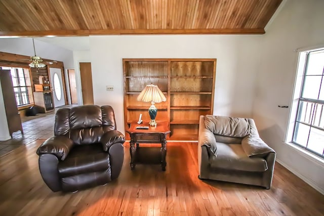 living area with lofted ceiling, wooden ceiling, wood finished floors, and a wealth of natural light