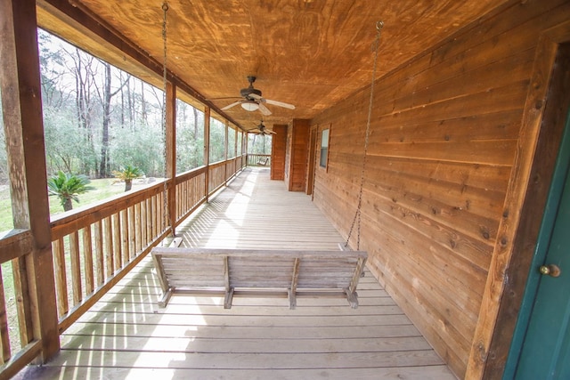 wooden terrace with a ceiling fan