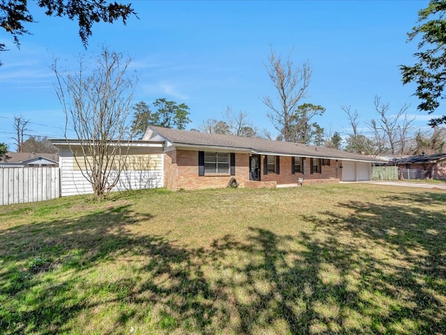 view of front facade featuring a garage, fence, a front lawn, and brick siding