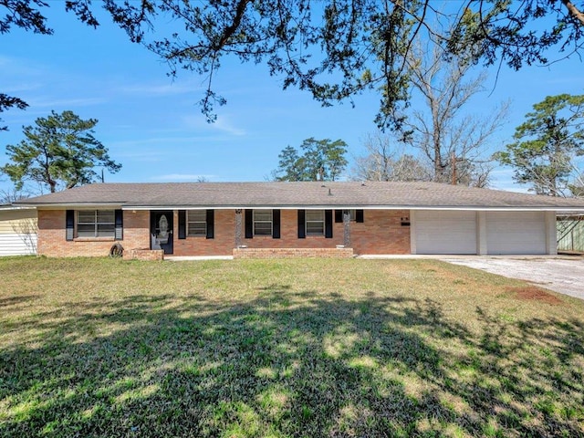 single story home with driveway, an attached garage, a front lawn, and brick siding