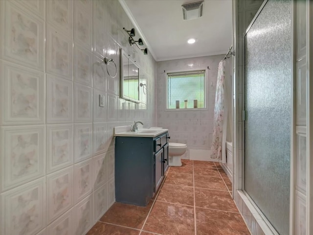 full bathroom featuring crown molding, tile walls, visible vents, toilet, and tile patterned floors