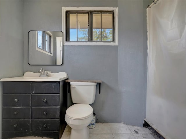 bathroom featuring tile patterned flooring, vanity, and toilet