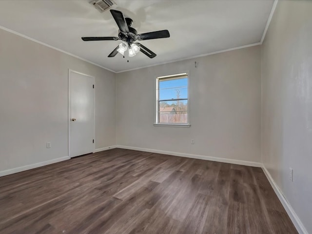 spare room with a ceiling fan, visible vents, baseboards, dark wood-style floors, and crown molding