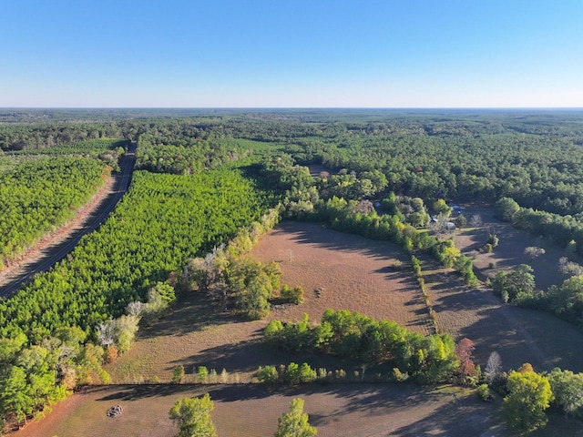 birds eye view of property featuring a view of trees