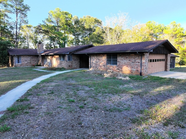 single story home with brick siding, concrete driveway, a front yard, a chimney, and an attached garage