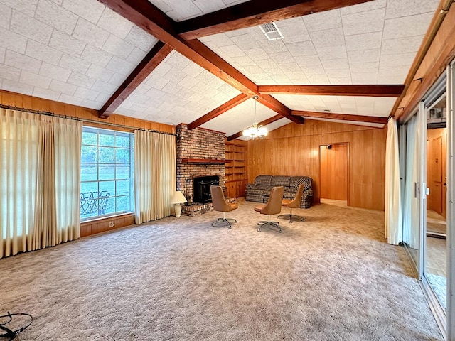 unfurnished living room featuring visible vents, lofted ceiling with beams, carpet floors, wood walls, and a fireplace