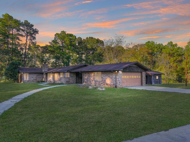 view of front of property with a front lawn, an attached garage, driveway, and a chimney