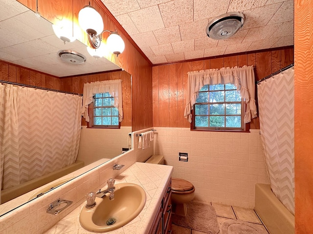 bathroom featuring a healthy amount of sunlight, vanity, toilet, and crown molding