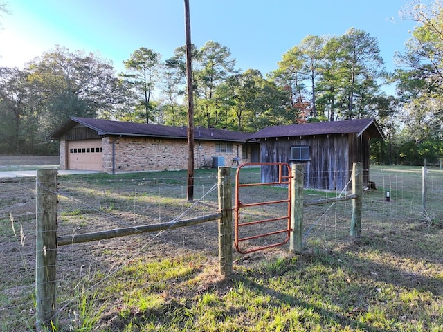view of front of house with brick siding, fence, a garage, driveway, and a gate