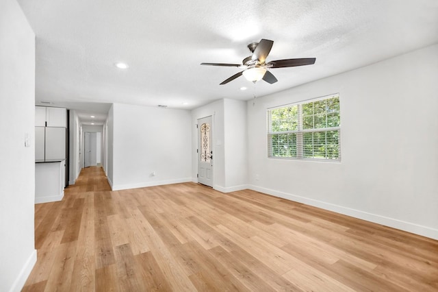 175 Weeks St, Lufkin, TX 75904 - empty room with light wood-style flooring, ceiling fan, recessed lighting, and a textured ceiling