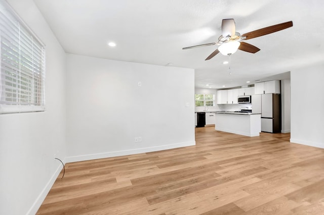 175 Weeks St, Lufkin, TX 75904 - unfurnished living room featuring a ceiling fan, recessed lighting, and light wood-style floors