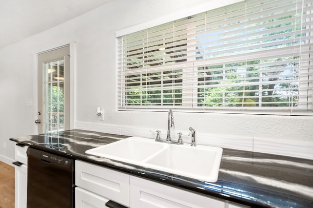 175 Weeks St, Lufkin, TX 75904 - kitchen with black dishwasher, white cabinetry, dark countertops, and wood finished floors