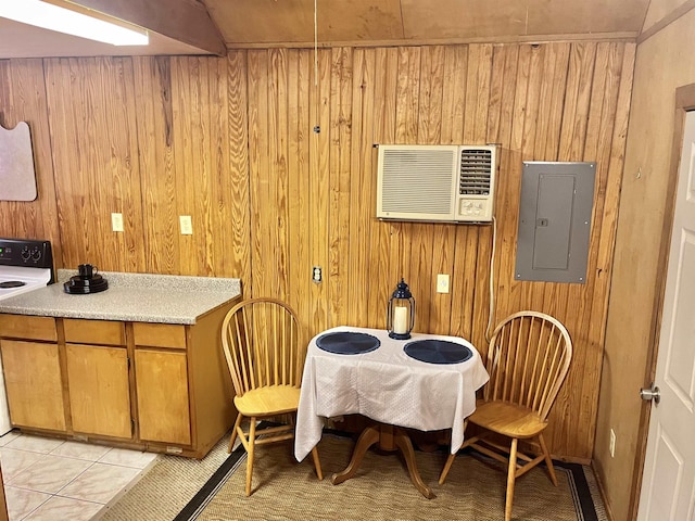 tiled dining area with a wall mounted air conditioner, electric panel, and wooden walls