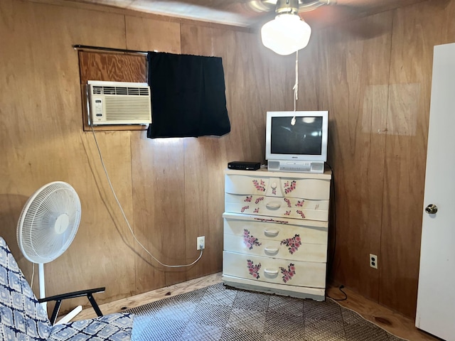 interior space with a wall mounted AC and wooden walls