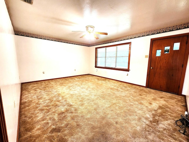 entryway featuring carpet flooring, baseboards, and a ceiling fan