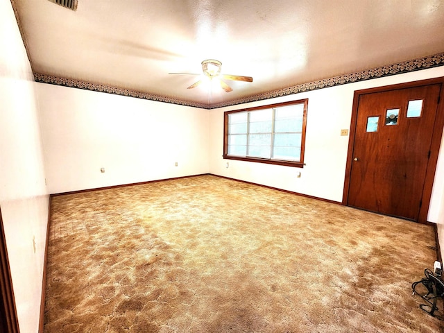 carpeted foyer featuring ceiling fan and a textured ceiling