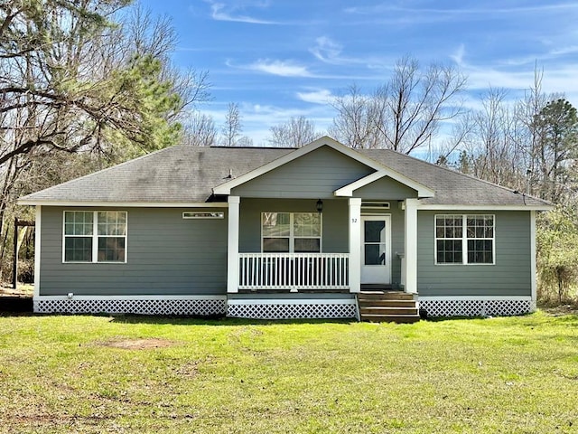 view of front of house featuring a front yard, covered porch, and roof with shingles