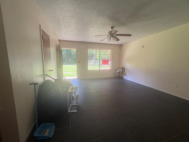 1169 County Road 619, Kirbyville, TX 75956 - spare room with a textured ceiling, ceiling fan, and baseboards